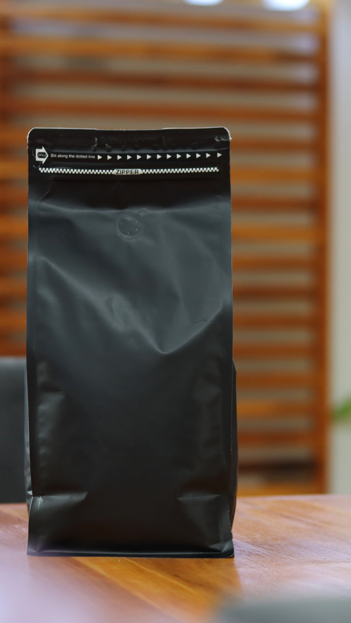 A matte black stand-up pouch with a resealable zipper closure, Soft-Touch Bottle Caps, Sealing Rings, Flexible Pouches, Resealable Closures.